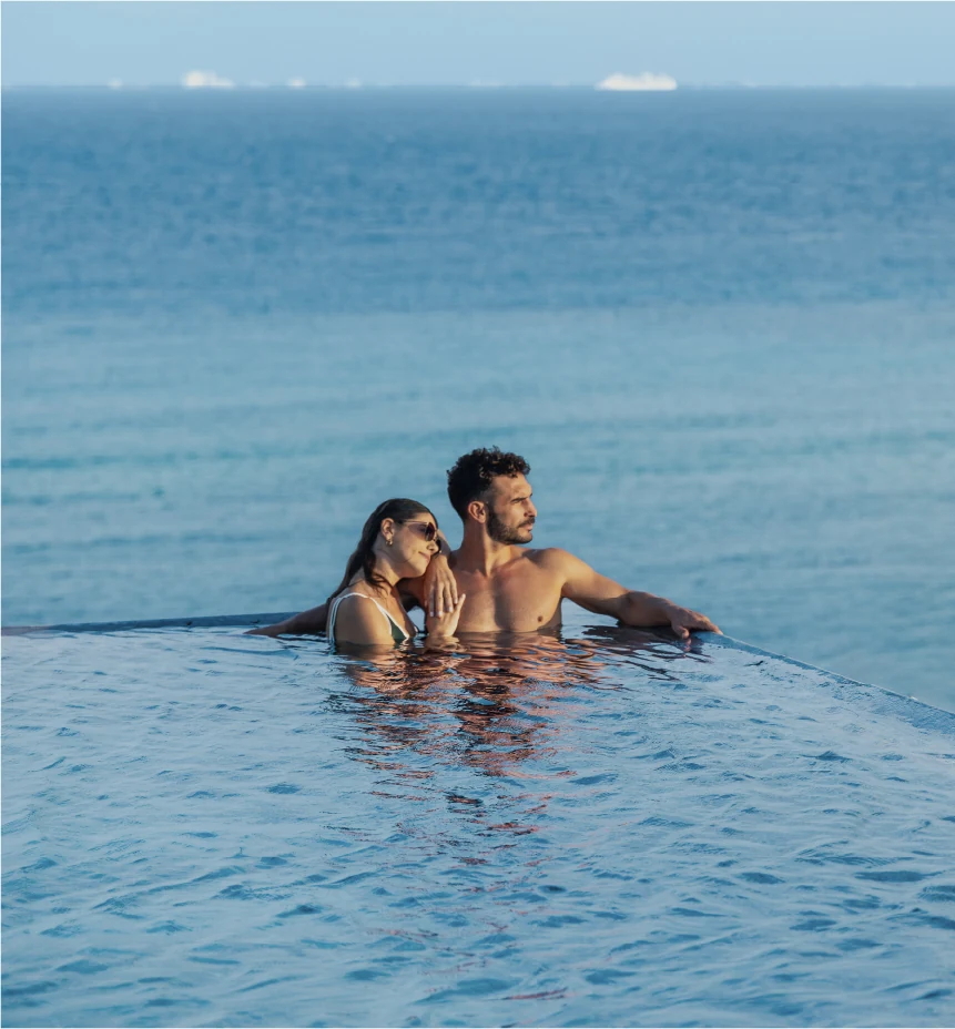 Couple enjoying an infinity-edge pool